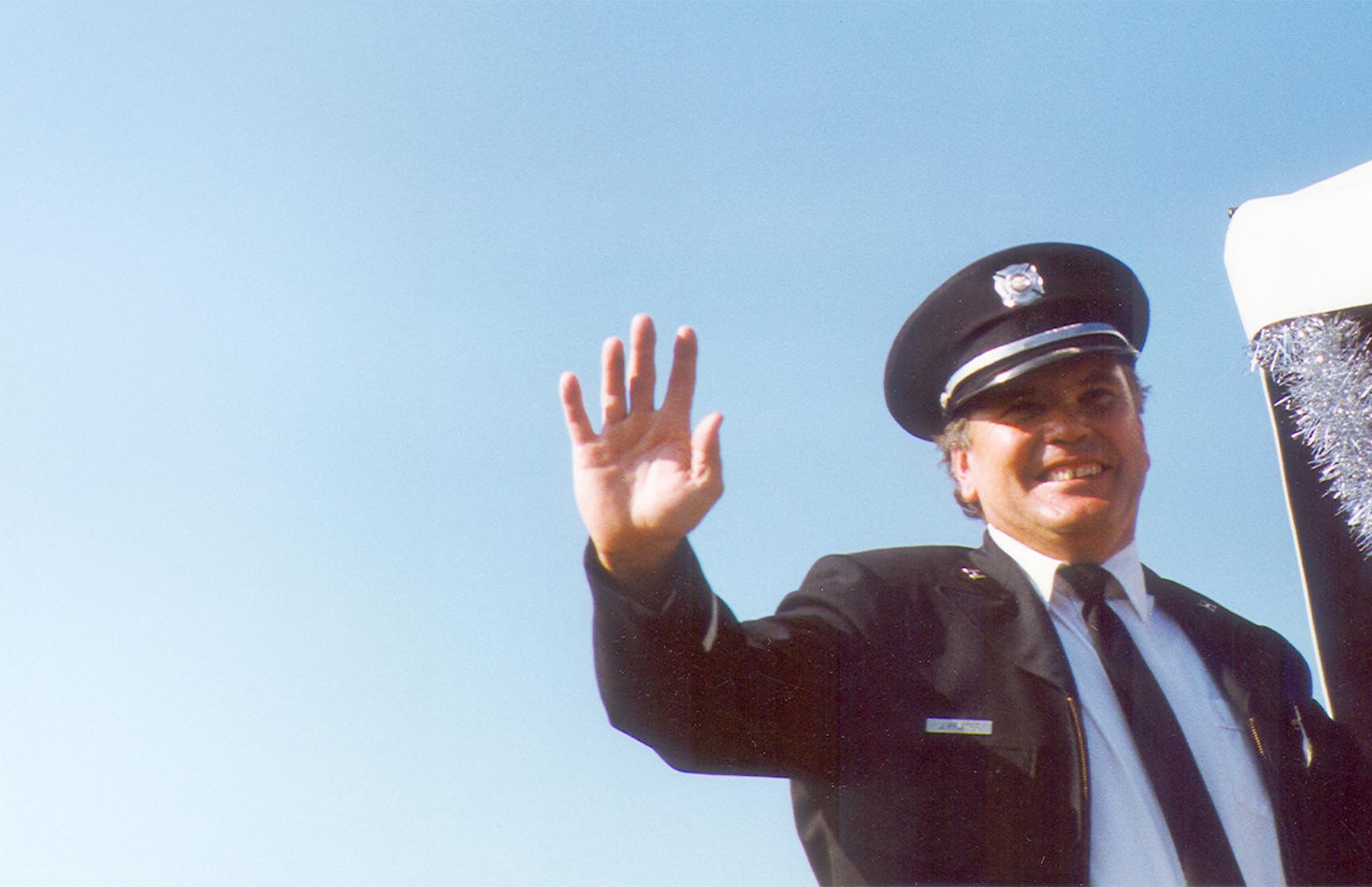 Jim waving from a parade float